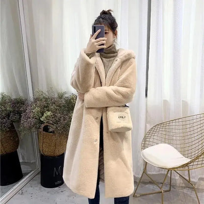 Luxurious women's long faux fur coat with a beautiful texture, spacious pockets, and full-length sleeves, elegantly blending comfort and glamour for winter wear.