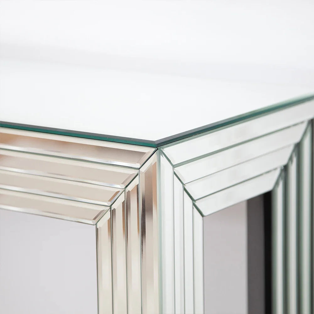 Elegant mirrored console table with contemporary design, showcasing a stylish glass tabletop ideal for home decor.