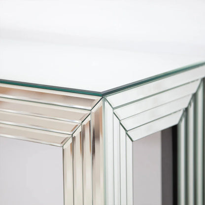 Elegant mirrored console table with contemporary design, showcasing a stylish glass tabletop ideal for home decor.