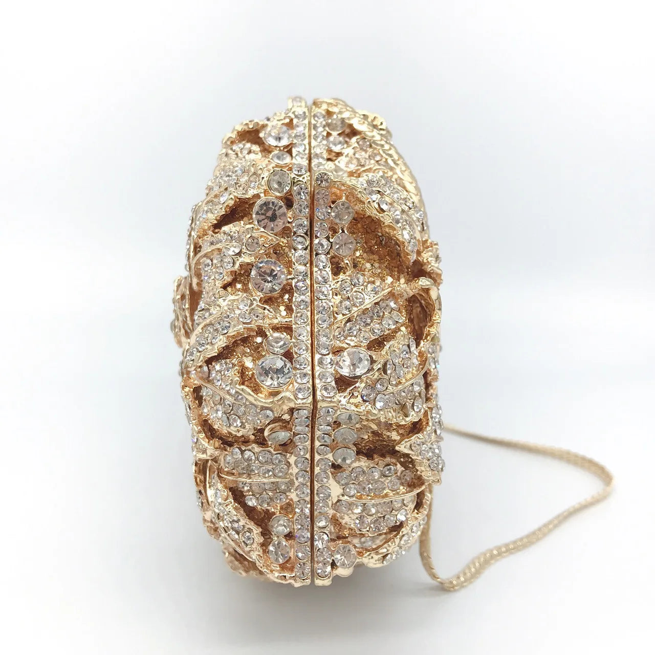 Elegant luxury women's minaudière clutch purse with sparkling crystal detailing and metallic leather design, perfect for evening events.