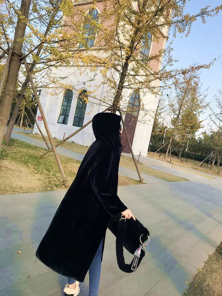 Close-up of luxury faux fur texture on women's long overcoat, highlighting plush comfort and sophisticated style ideal for winter.