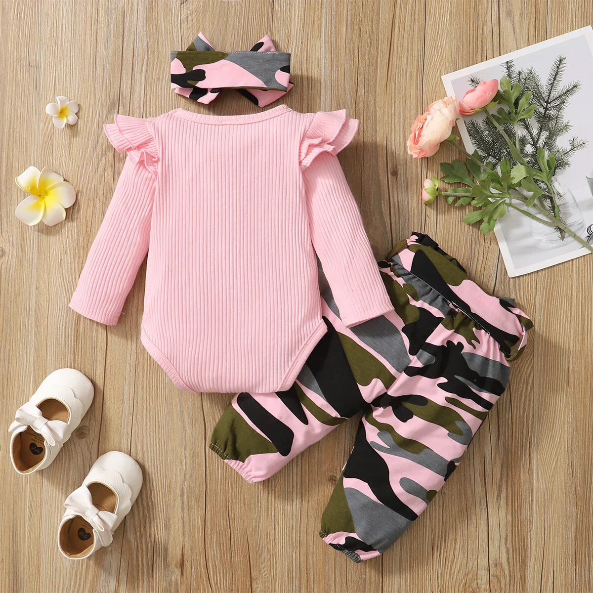 Stylish baby clothing set displayed on a soft background, including a fashionable vest and full-sleeve top in luxury camouflage design for infants.