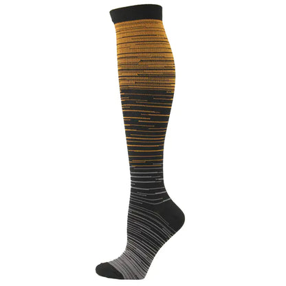 Men's and Women's activewear Flightwear Compression Stockings in gradient gold and black hues, combining luxurious style with performance enhancement.