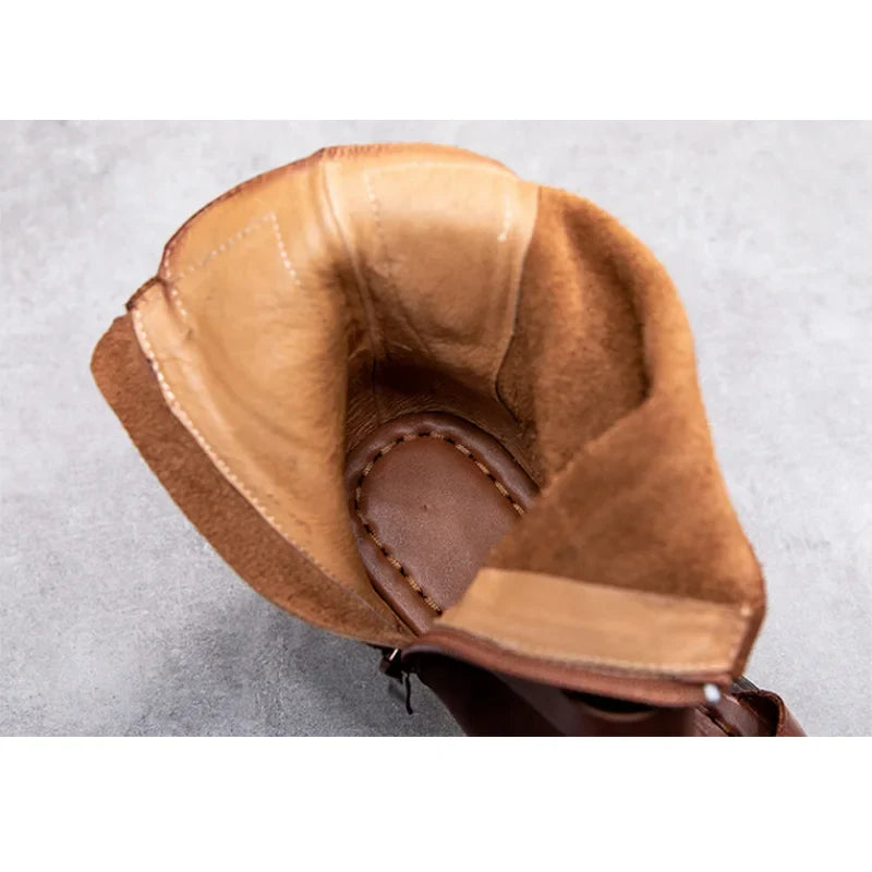 Close-up of handmade leather sandals, highlighting the intricate metal decoration and premium craftsmanship for sophisticated wear.