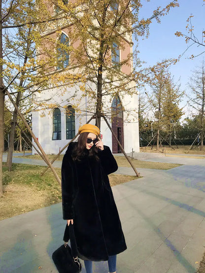 Chic women's hooded faux fur long overcoat displayed elegantly, emphasizing the sleek design and luxurious feel for casual winter wear.