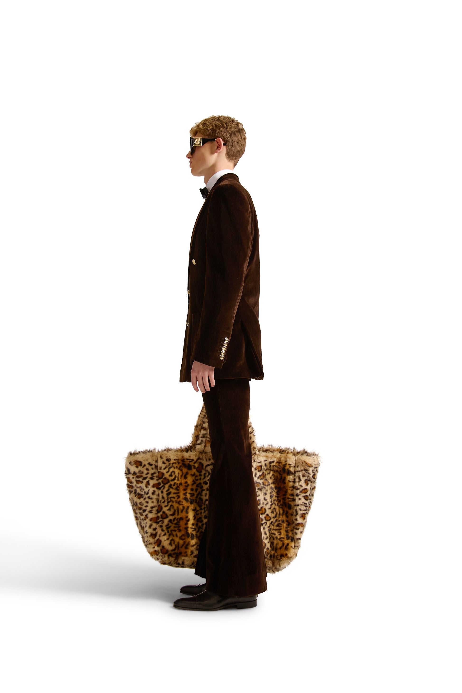 Luxurious oversized faux fur shoulder bag from Helen Anthony, featuring a stylish Italian design, with zippered pockets and a button closure in an elegant setting.