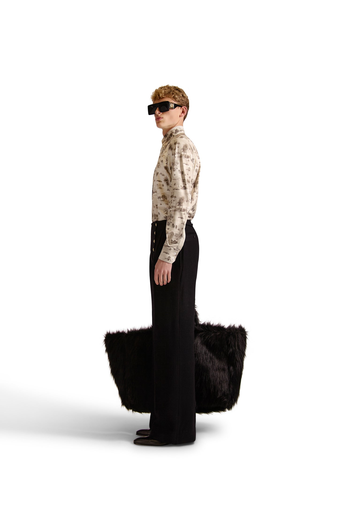 Side angle of the exclusive Helen Anthony long-sleeve shirt displaying its stylish curved hem and high-quality knitted fabric.