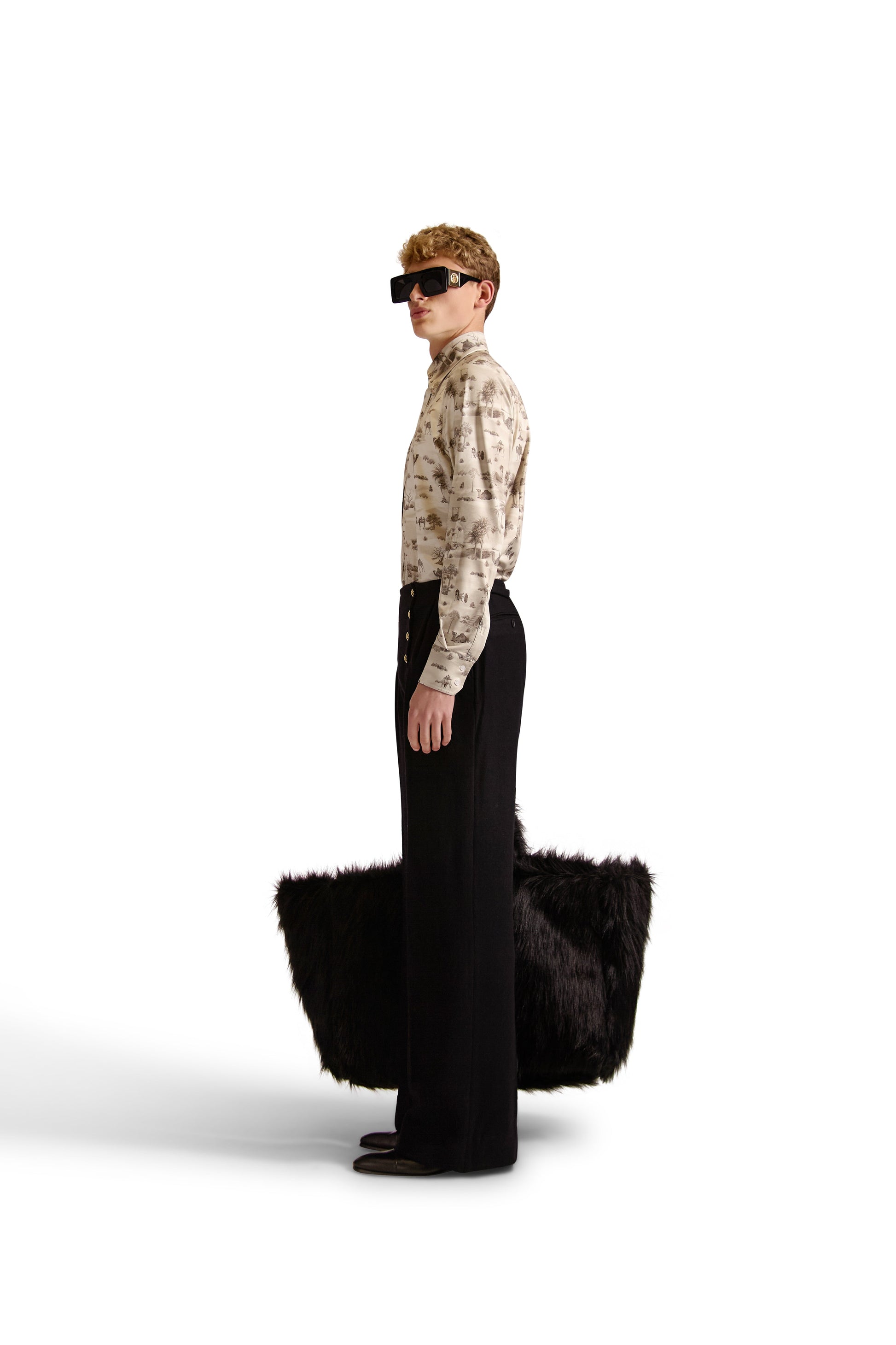 Side angle of the exclusive Helen Anthony long-sleeve shirt displaying its stylish curved hem and high-quality knitted fabric.