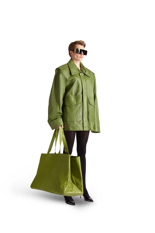 Detail of the interior of an oversized Italian leather shoulder bag showcasing multiple slip pockets and secure inside zips, combined with a chic button close pouch, epitomizing refined Italian craftsmanship.