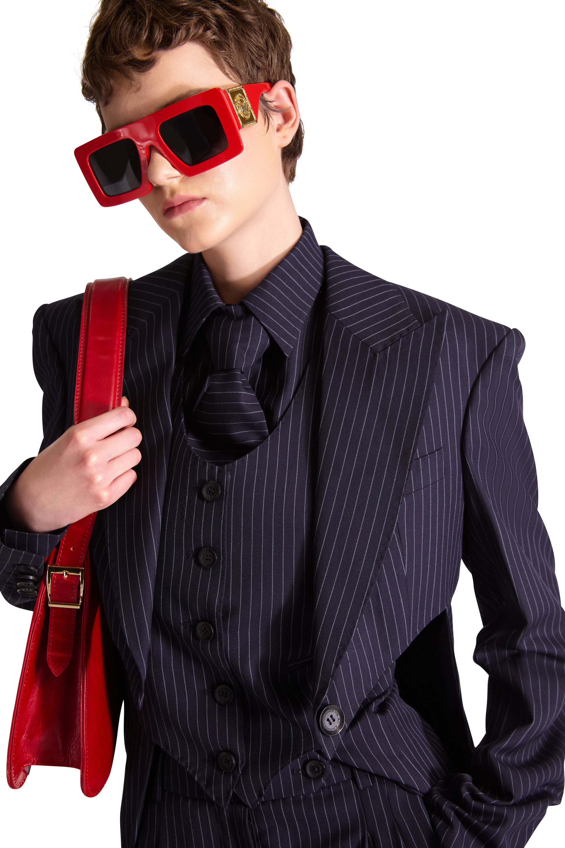 Chic small shoulder bag with enamelled magnetic snap closure and adjustable leather strap, designed for luxury.