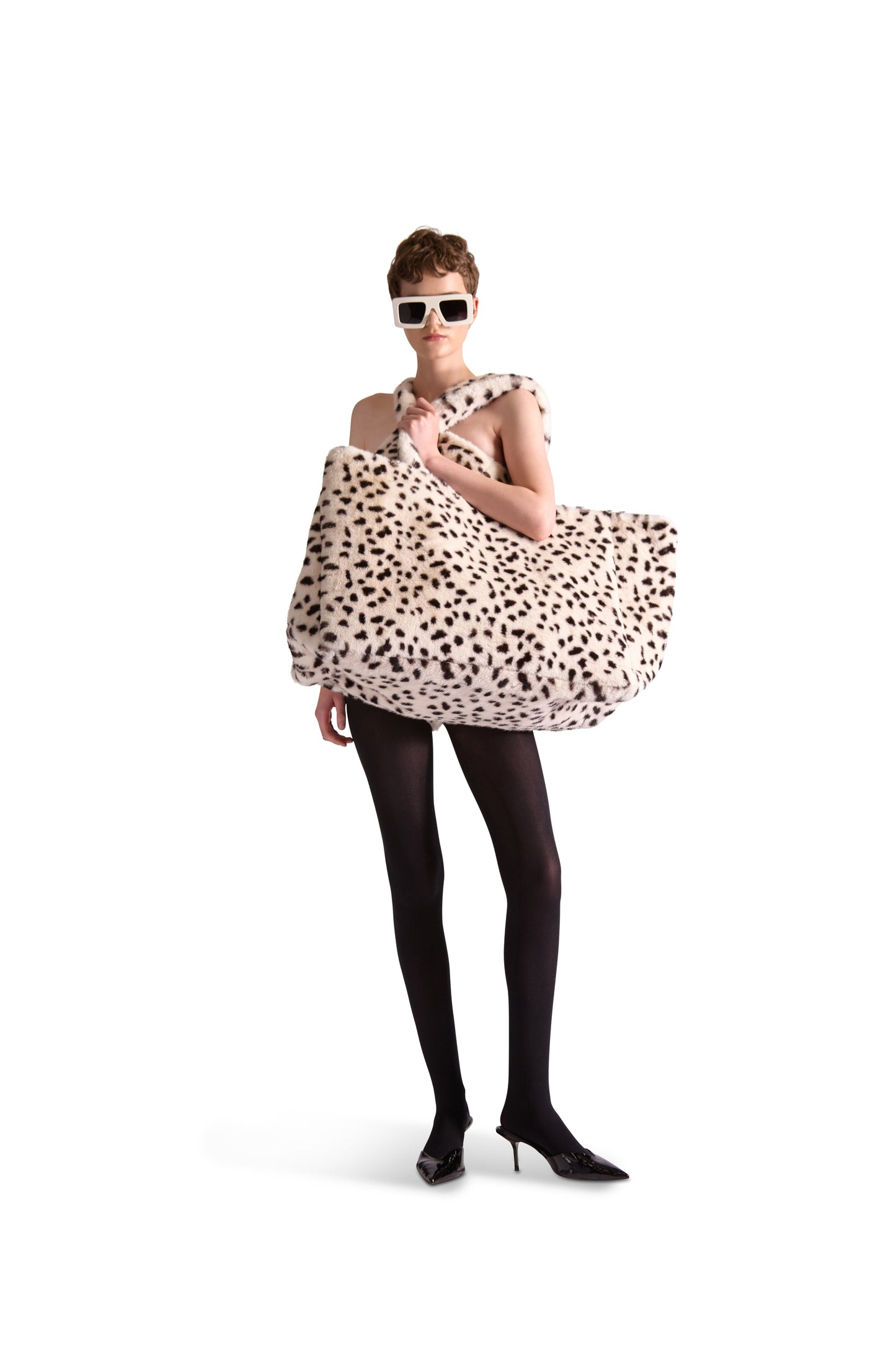 Luxurious oversized animal print faux fur shoulder bag featuring convenient zip pockets and an elegant button close pouch.