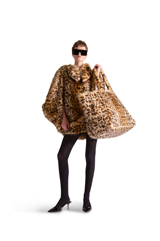 Luxury oversized animal print faux fur shoulder bag with inside zips, button close pouch, and multiple slip pockets, showcasing its opulent design and Italian craftsmanship.