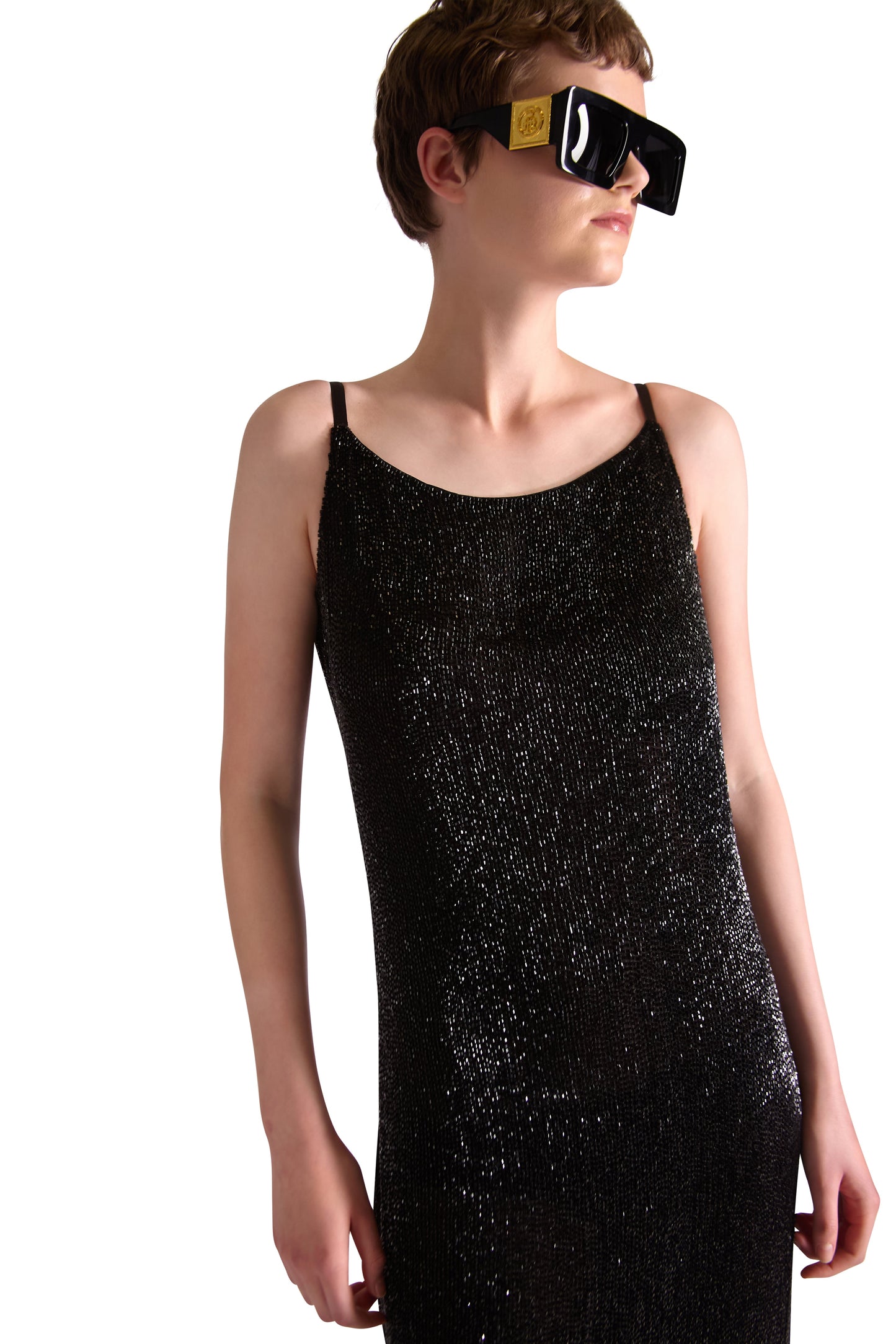 Back view of the luxurious silk-lined beaded evening dress revealing its graceful silhouette and exquisite rounded neckline.