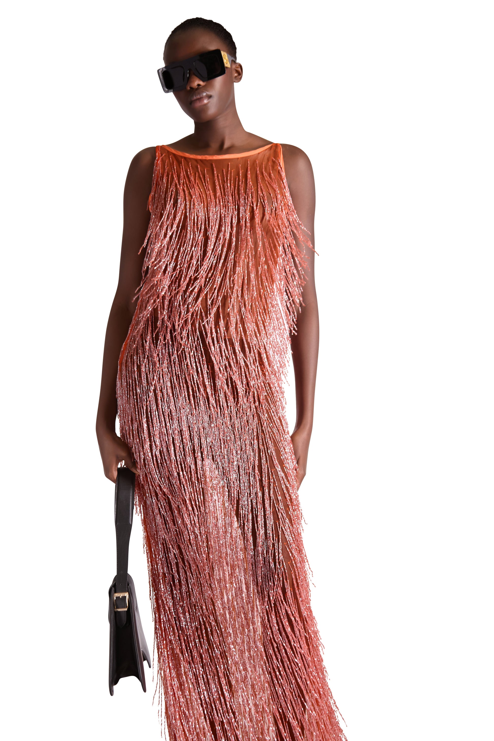 Elegant hand embroidered beaded tassel detail on sleeveless sheer evening dress crafted from premium mesh fabric, made in Italy.