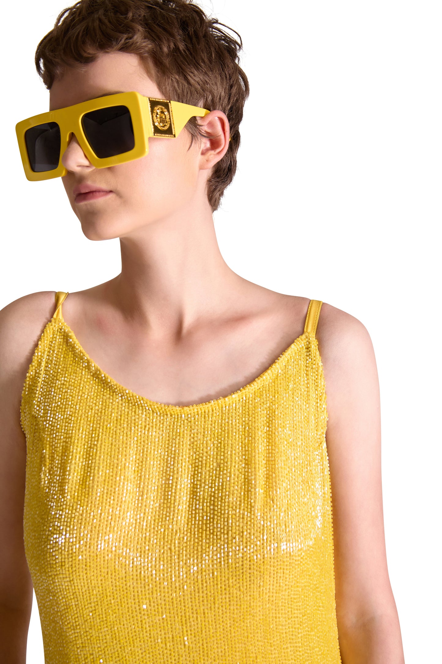 Beautiful detail of the hand embroidered Katdana beads on a luxury floor length evening dress, showcasing exquisite craftsmanship and elegant spaghetti straps.