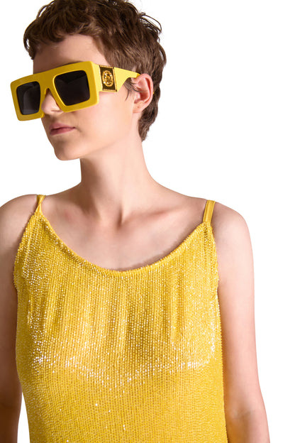 Beautiful detail of the hand embroidered Katdana beads on a luxury floor length evening dress, showcasing exquisite craftsmanship and elegant spaghetti straps.