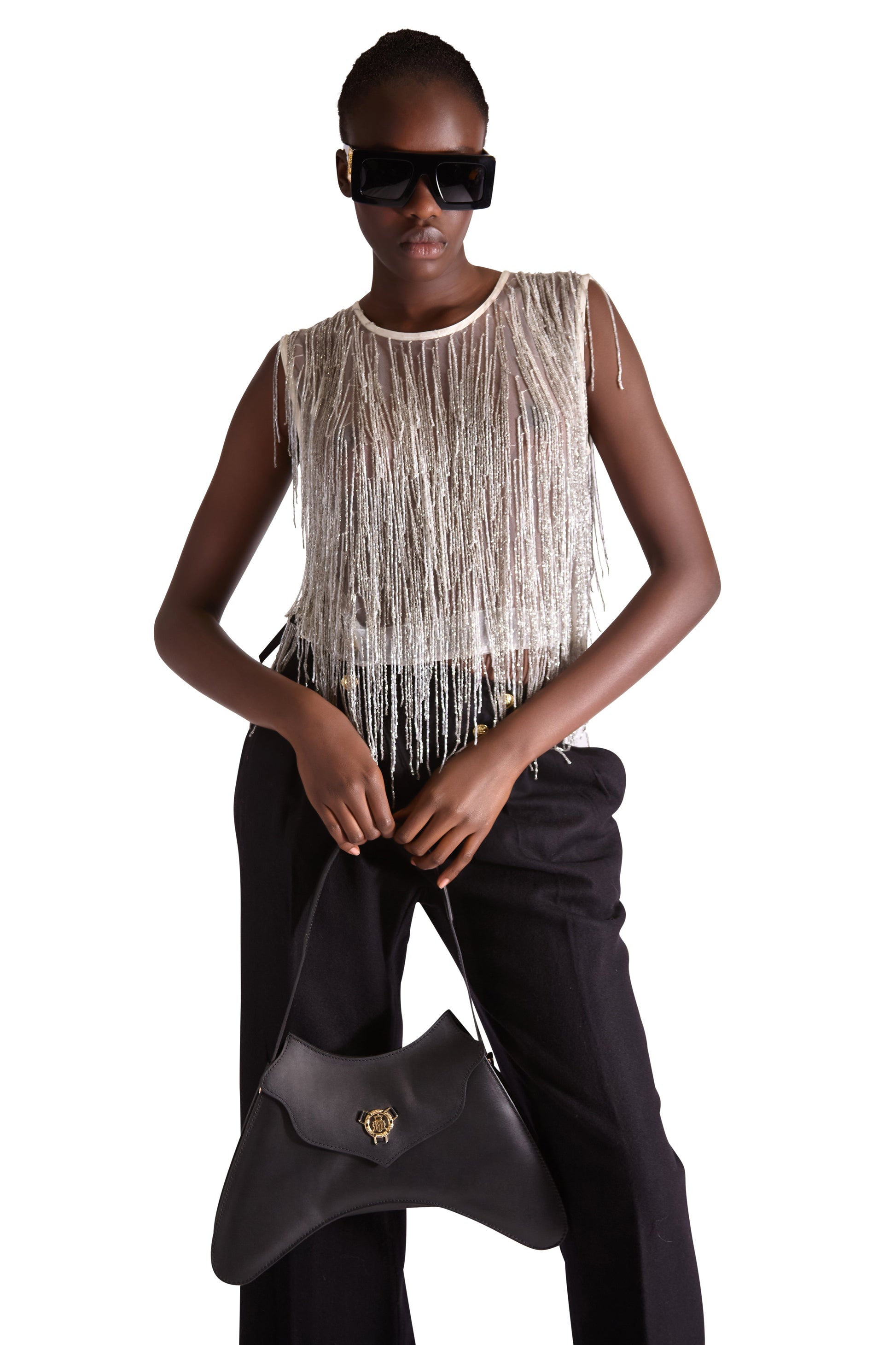 Fashionable round neckline of the hand embroidered beaded tassel top by Helen Anthony, highlighting the elegance and refinement of this unique mesh fabric piece.