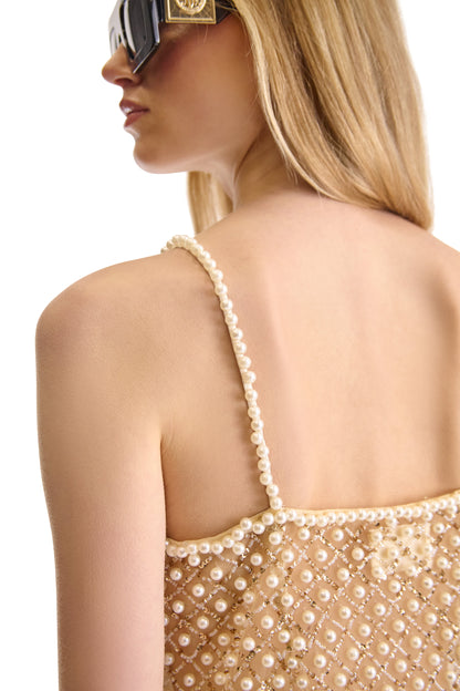 Impeccably designed sheer dress with luxurious pearl embellishments, featuring spaghetti straps and a refined silhouette, made in Italy.