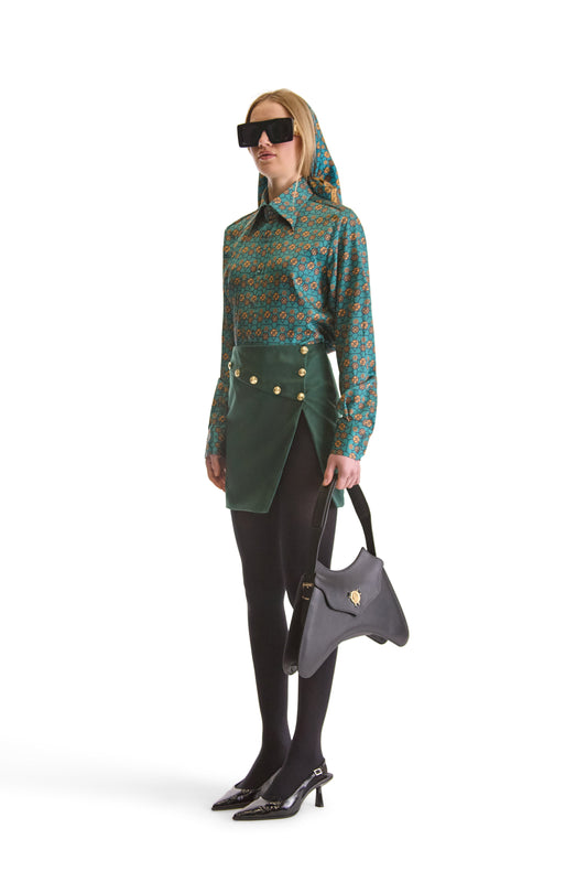 Close-up view of Helen Anthony's exclusive monogram print shirt, showcasing the intricate woven fabric and two-button mitered cuffs.