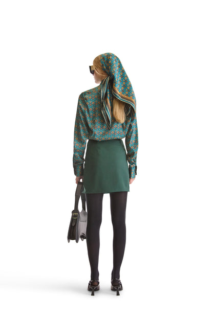 Elegant presentation of Helen Anthony's exclusive geometric monogram silk scarf on a stylistic background, embodying Italian luxury.