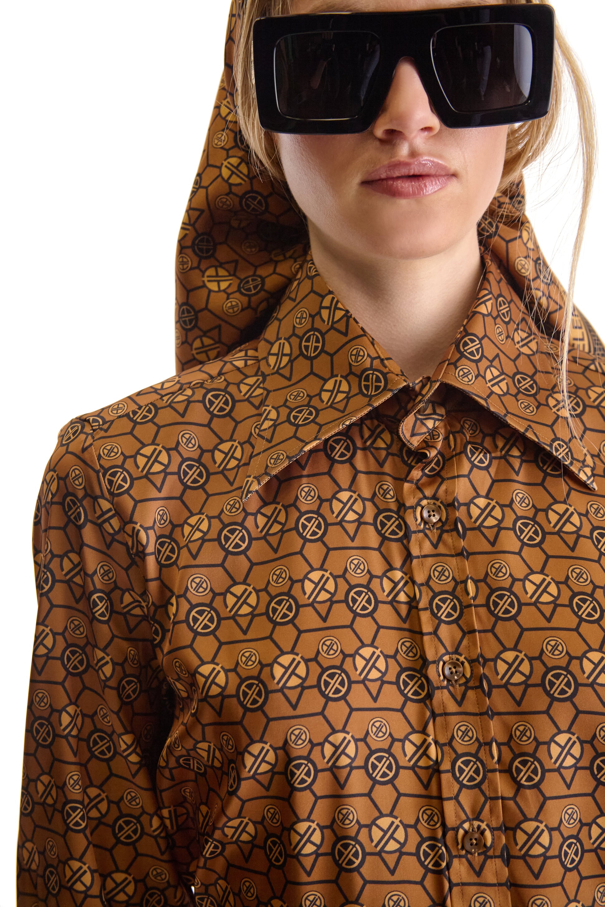 Detail of the two-button mitered cuffs and concealed one-button pleated placket on a luxury tailored shirt, symbolising elegance.