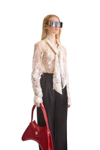 Luxurious Helen Anthony sheer white blouse showcasing intricate floral hand embroidery and elegant scarf collar, designed in Italy.