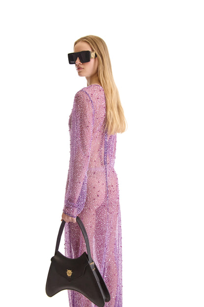 Stylish round neckline and back zip closure of an elegant long sleeve evening dress, designed for a glamorous evening event.