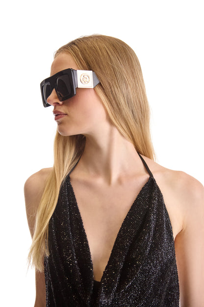 Luxury hand embroidered backless evening dress with a tie neckline, featuring intricate bead detailing and silk lining. Elegant curved hemline and back zip closure, designed for high-end fashion sophistication, made in Italy.