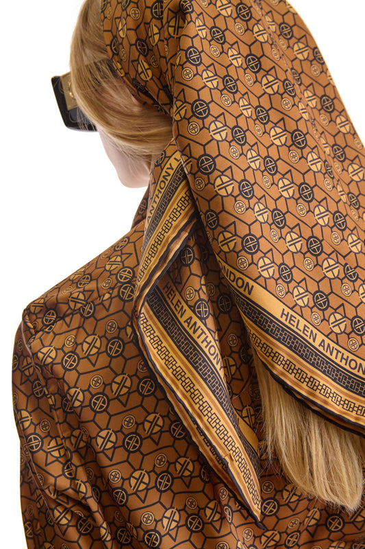 Elegant twill silk scarf displaying the Helen Anthony logo in a chic monogram print, crafted with exquisite perfection and smooth hand-finished trim, ideal for luxury styling.