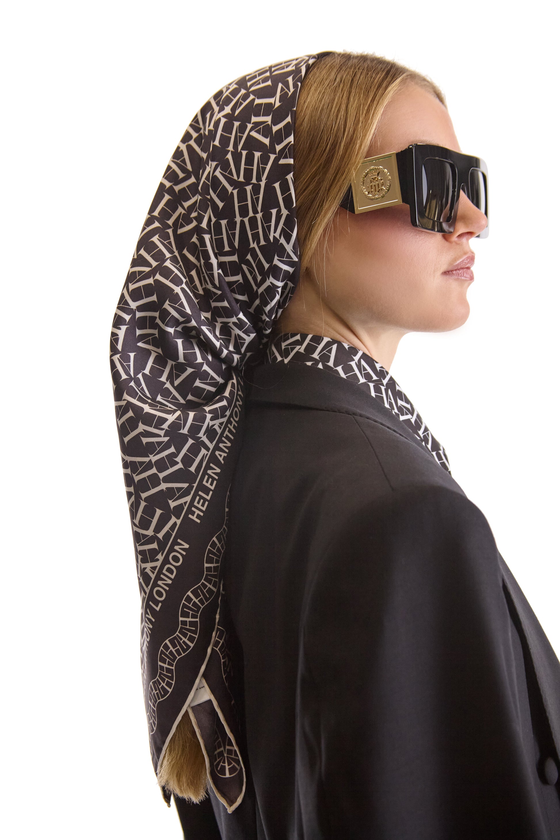 Flat lay of Helen Anthony monogram silk scarf, 90 x 90 cm, made in Italy, highlighting the soft texture and luxurious feel of 100% silk in an elegant design.