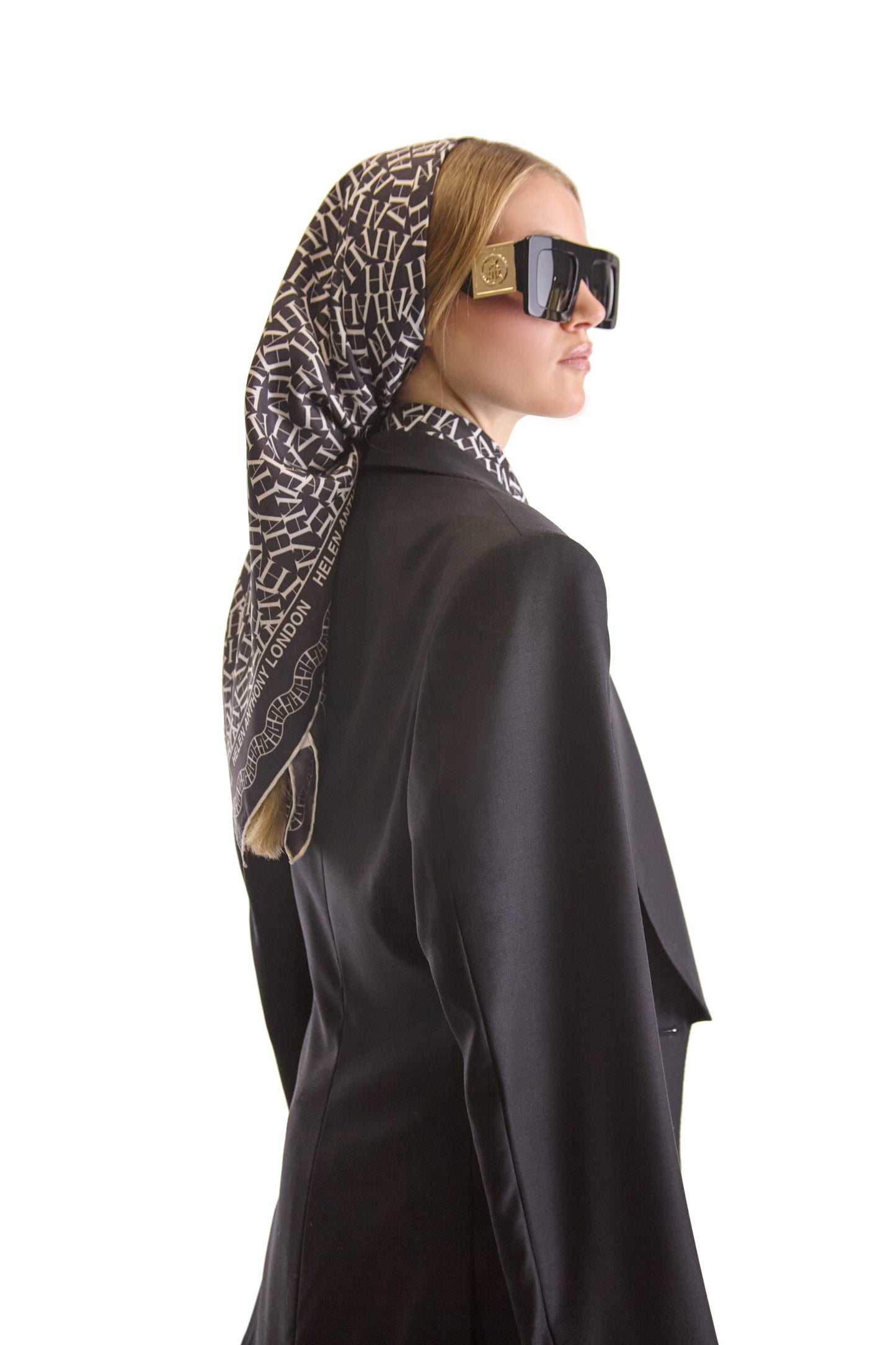 Stylish display of the Helen Anthony silk scarf draped, showcasing its graceful drape and stunning monogram print, a perfect accessory for sophisticated attire.