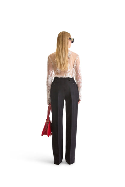 Elegant long sleeve sheer blouse with scarf collar, highlighting intricate floral embroidery against delicate mesh fabric, designed in Italy.