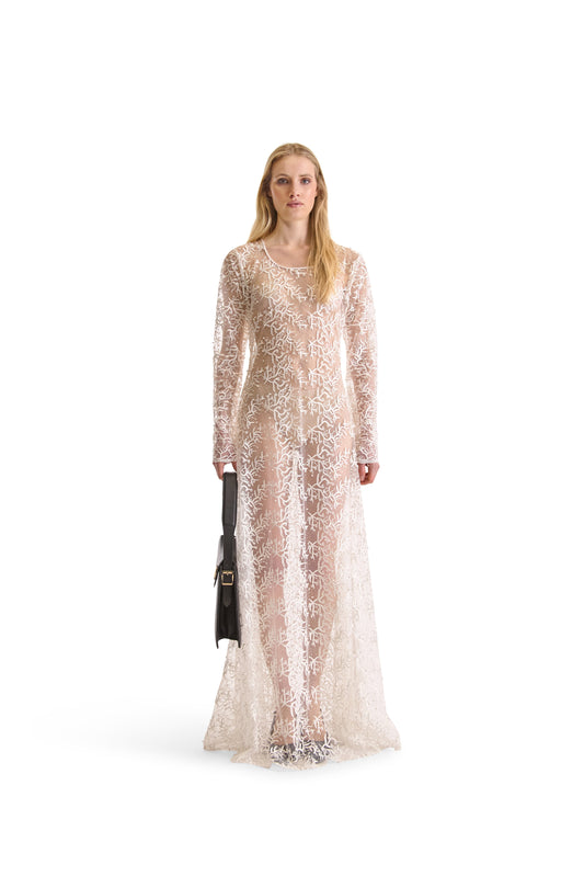 Elegant long sleeved sheer evening dress featuring exquisite hand embroidered beads, made in Italy, showcasing a sophisticated mesh fabric design.