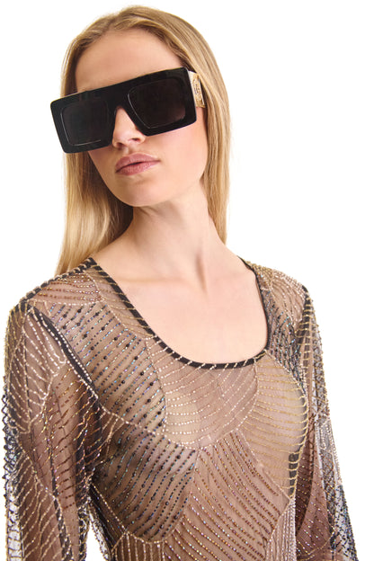 Luxurious sheer evening dress with long sleeves and intricate hand embroidery, featuring a stylish back zip closure, crafted in Italy.