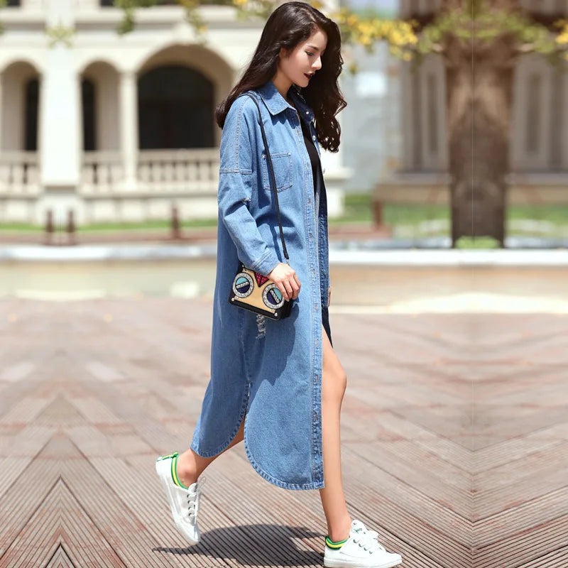 Luxurious plus size denim trench coat for women featuring a stylish hollow design and long, fashionable silhouette, perfect for casual outerwear.