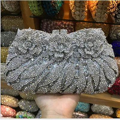 Stylish minaudiere evening clutch showcasing a sleek solid design adorned with shimmering rhinestones, ideal for elegant events.
