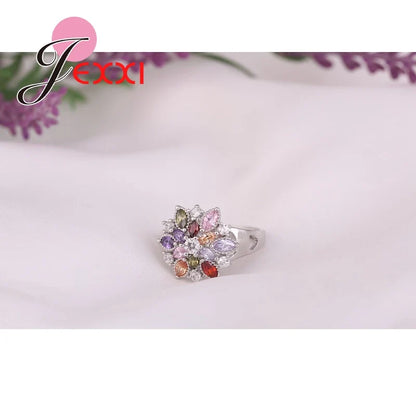 Charming flower-shaped ring in 925 sterling silver with intricate details, adorned with dazzling zircon jewels, ideal for special occasions or everyday elegance.
