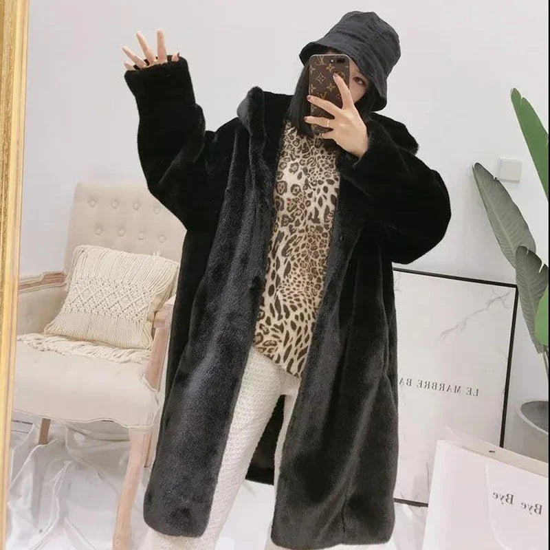 Chic and warm women's faux fur coat designed with a luxurious long length and fur-trimmed hood, ideal for winter fashion.