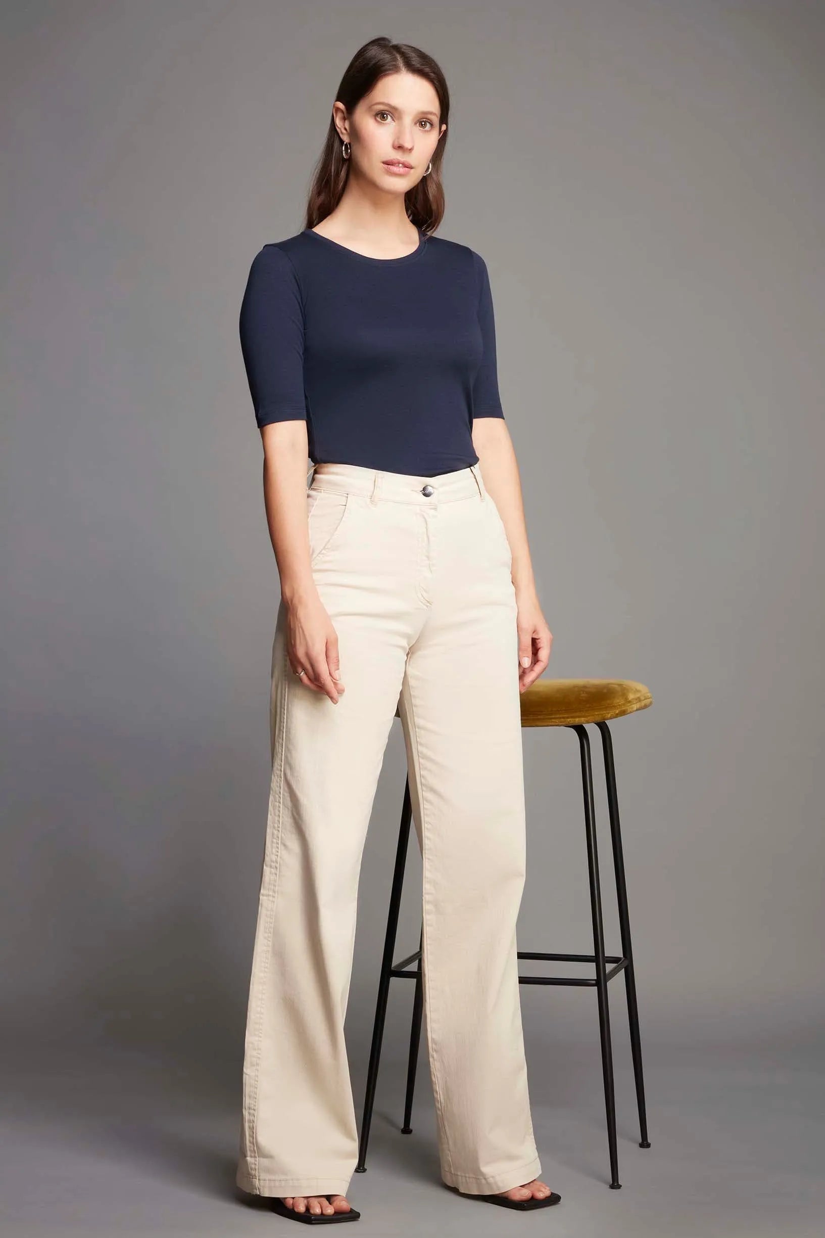 Model wearing a stylish half sleeve crew neck t-shirt, demonstrating versatility for both work and leisure outfits.