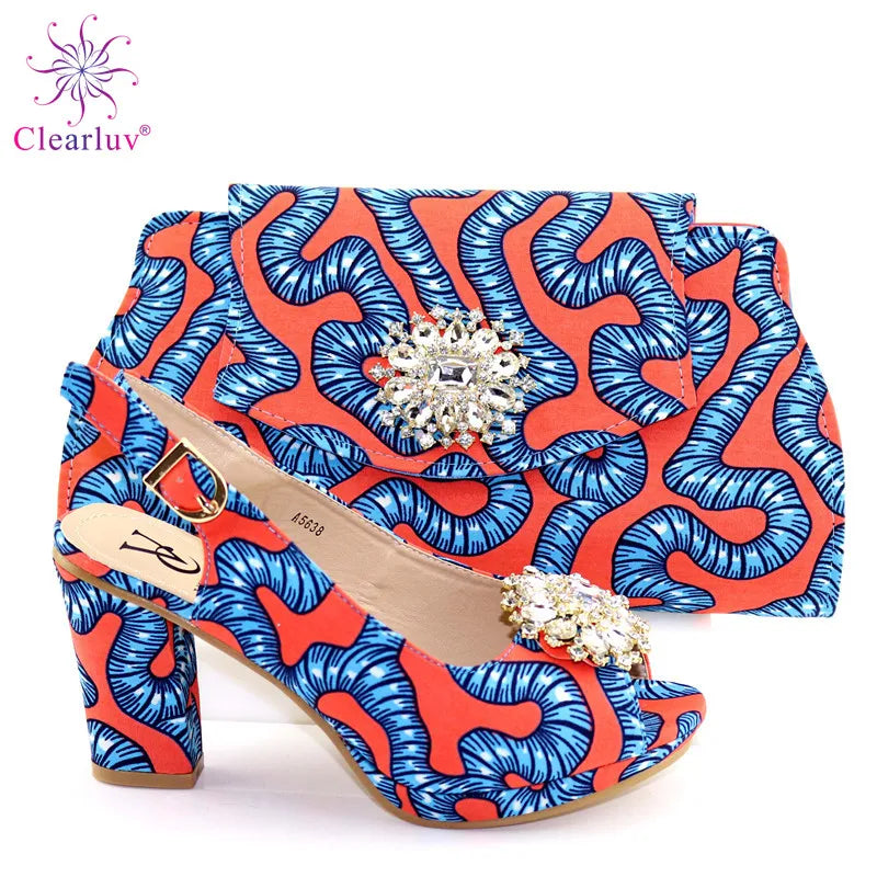 Chic red matching handbag accompanying elegant summer sandals, part of a luxurious set for women celebrating African fashion.