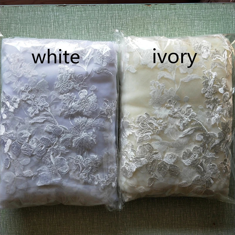 Close-up view of the intricate applique details on the edge of a luxurious cathedral wedding veil.