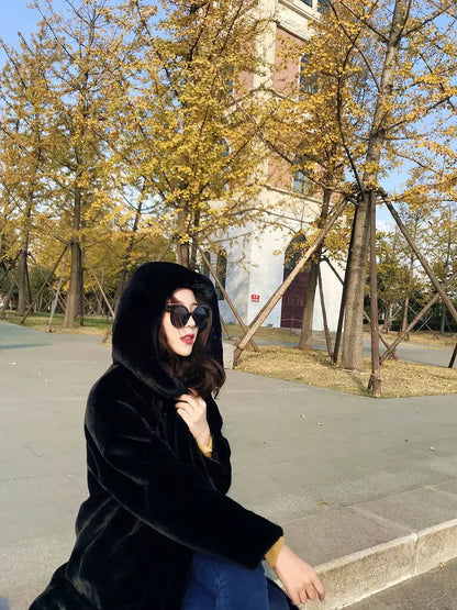 Women's luxury faux fur hooded long overcoat, showcasing elegant pockets and thick warm fabric, perfect for winter elegance.