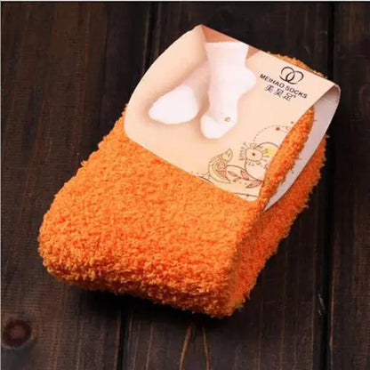 Elegant Women's Bed Socks in vibrant orange hue, made from soft coral fleece, designed to keep your feet toasty warm during the festive winter season.