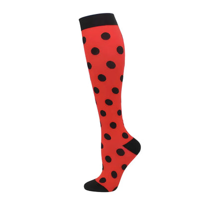 Women's Knee Length Compression Travel Socks for Comfort, Style, and Circulation featuring vibrant red colour with bold black polka dots, perfect for fashionable travel.