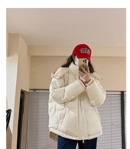 Chic winter look featuring a luxury women's hooded jacket crafted with cotton and polyester, perfect for cold weather elegance.