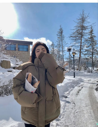 Close-up of the luxurious fabric and detail of the women's hooded down cotton jacket, emphasizing quality craftsmanship and winter comfort.