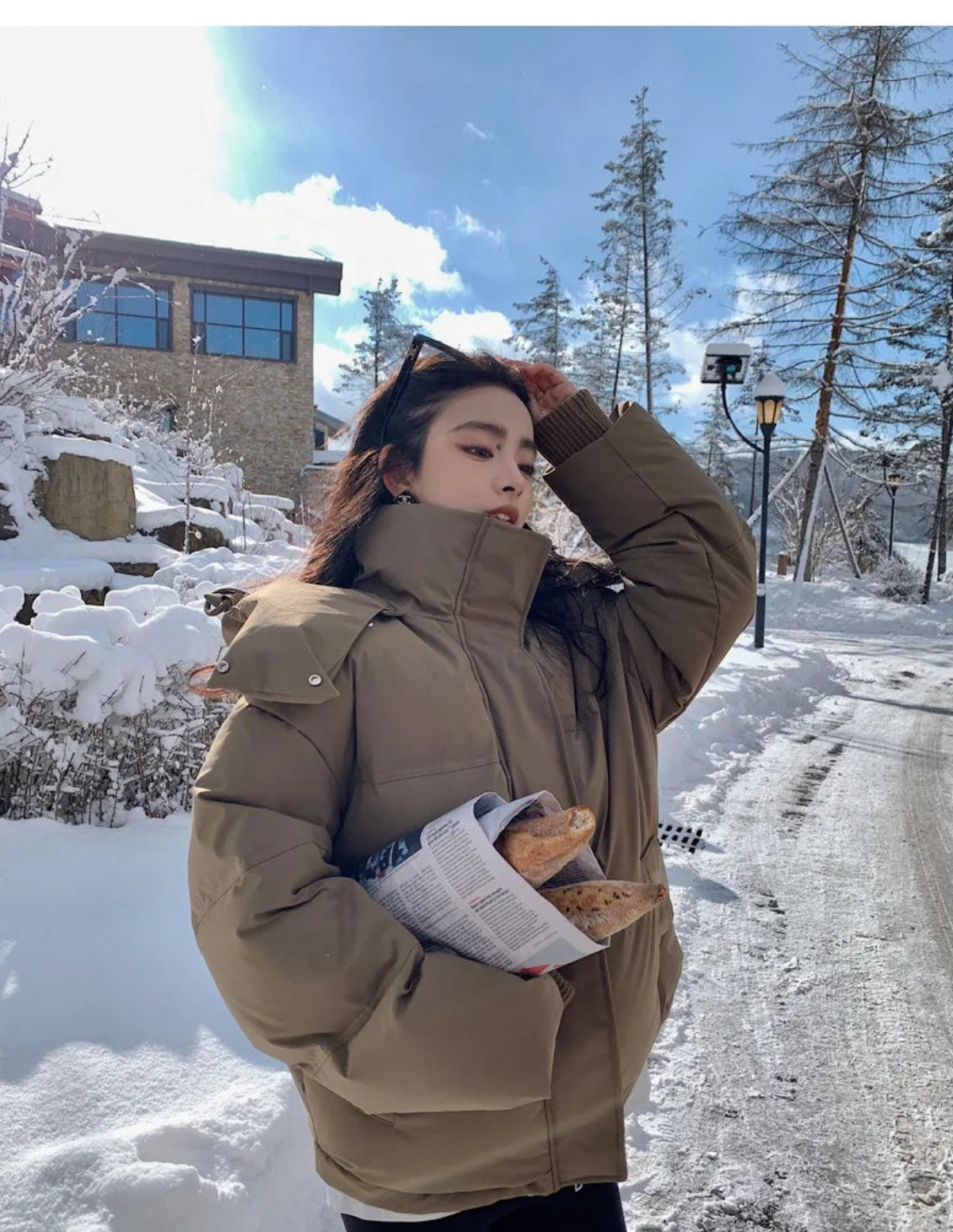 Fashionable women's thick warm hooded down jacket with elegant pockets, ideal for winter outings, epitomising style and warmth.