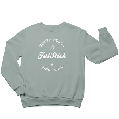 Luxurious FatStick South Coast Eco-Friendly Unisex Lifestyle Sweater in a picturesque outdoor setting, showcasing the stylish flock printed logo.