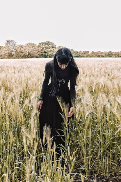 Back view of the Dark In Love Lux Black Velvet Maxi Dress highlighting the exquisite craftsmanship and flowing design, a perfect addition to any gothic wardrobe.