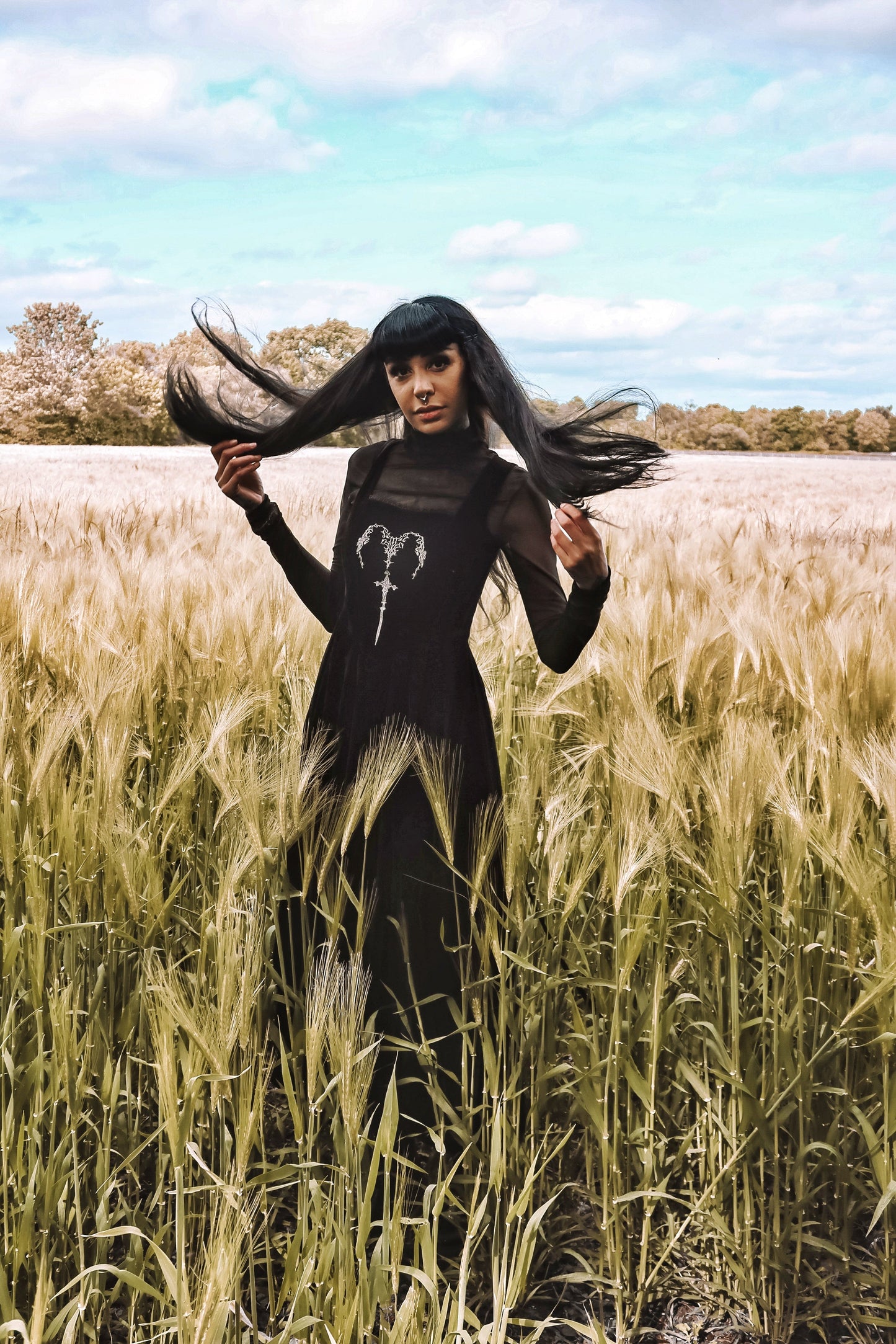 Side angle of the Dark In Love Lux Black Velvet Maxi Dress, emphasizing the elegant square neckline and luxurious fabric, designed for those with a taste for dark elegance.